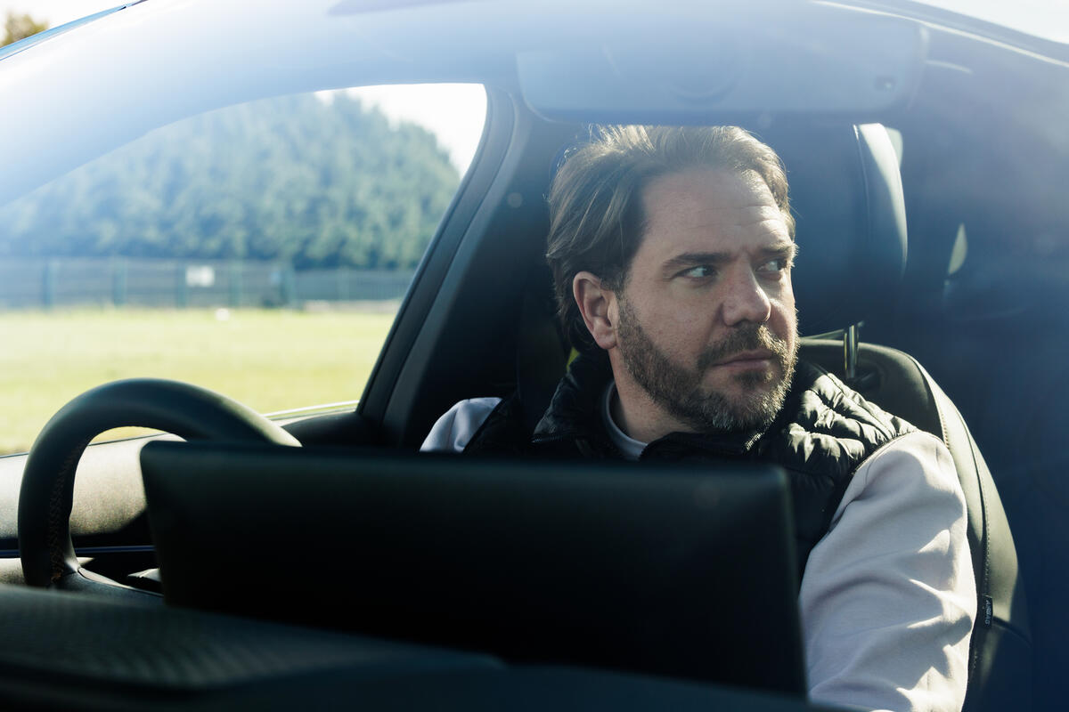 Adam Gray Shot of Adam Gray sat inside the cabin of a car.